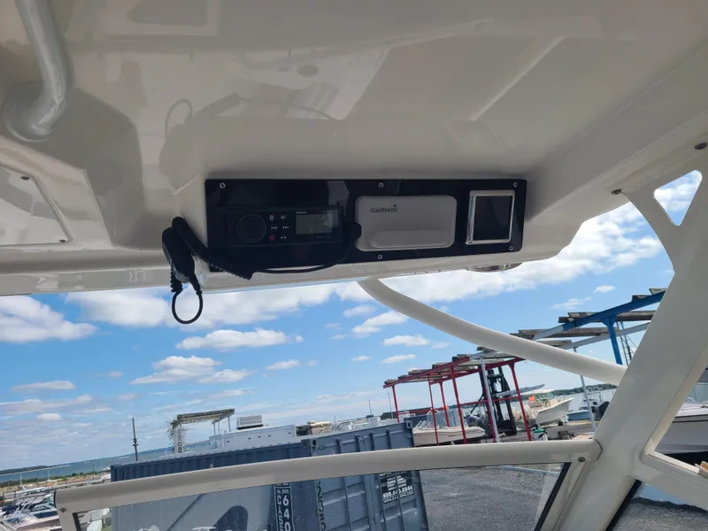 Slide: The Image of 2018 Edgewater 262 CX boat interior with Garmin electronics, clear sky view. - 8