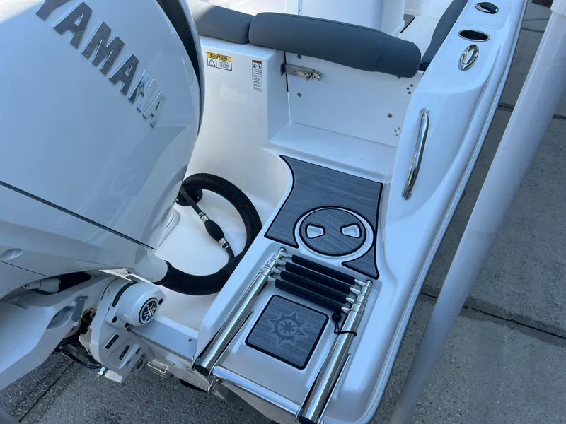 Slide: The Image of 2025 NauticStar 252L boat with Yamaha engine, featuring a sleek swim platform and ladder. - 11