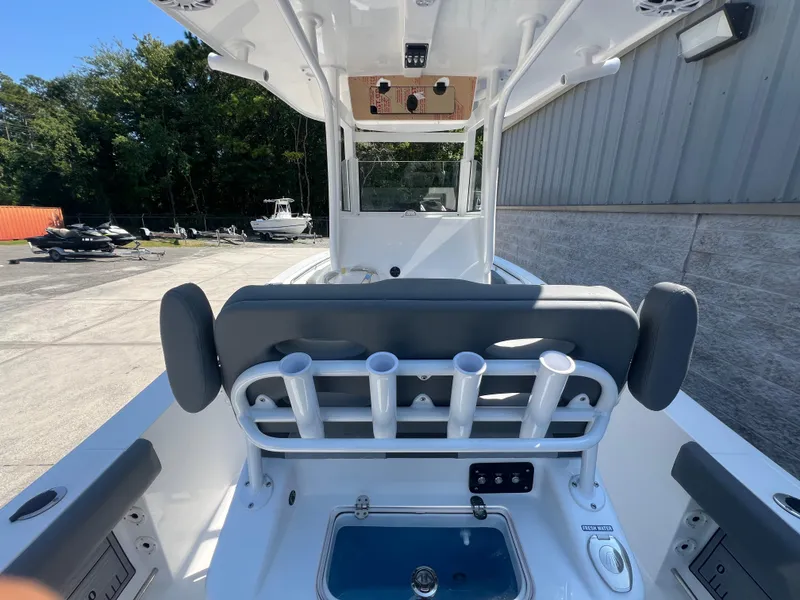 Slide: The Image of 2025 NauticStar 252L boat interior with rod holders and seating. - 13