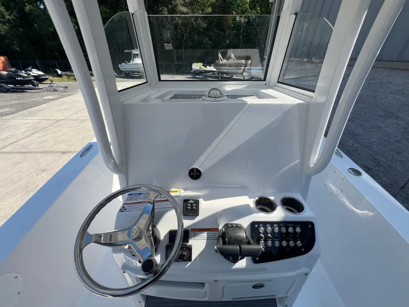 Slide: The Image of 2025 NauticStar 252L boat console with steering wheel and controls. - 15