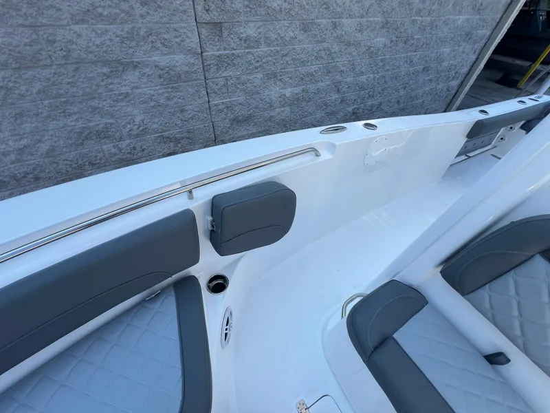 Slide: The Image of 2025 NauticStar 252L boat interior with gray seating and sleek design. - 31