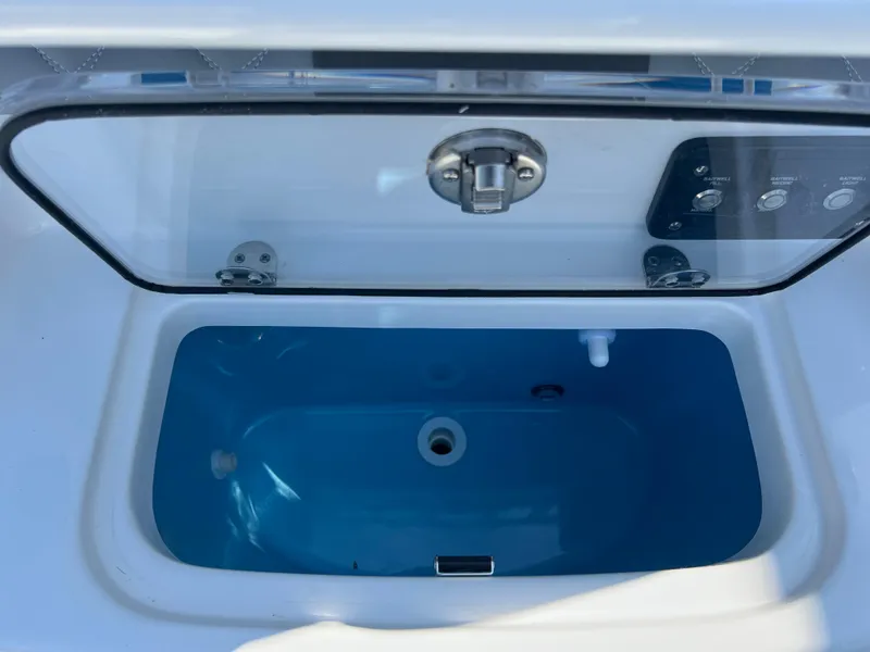 Slide: The Image of Open livewell on 2025 NauticStar 252L boat, featuring a blue interior. - 42