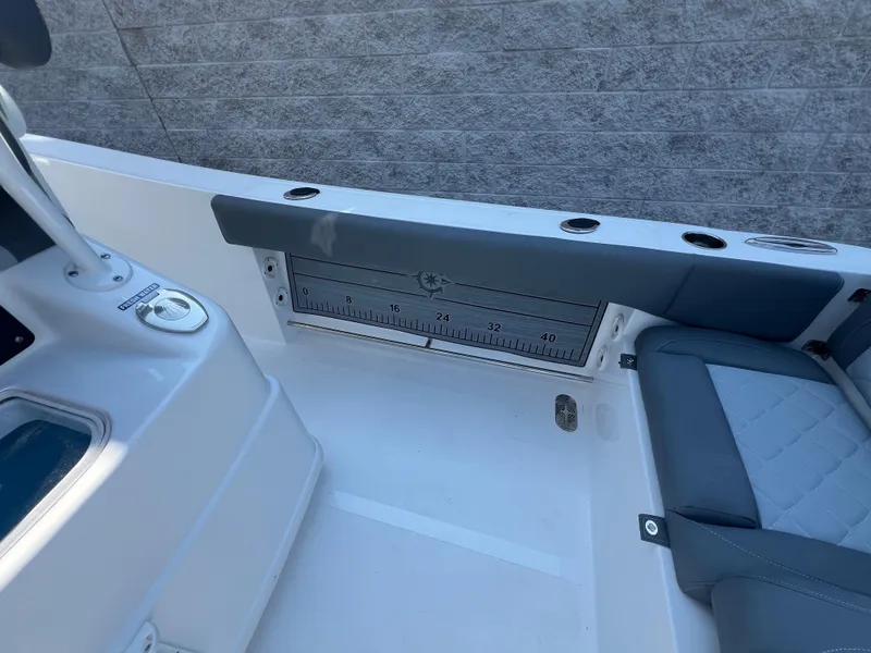 Slide: The Image of 2025 NauticStar 252L boat interior with seating and built-in measuring ruler. - 43