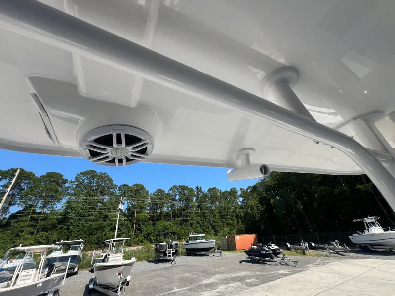 Slide: The Image of 2025 NauticStar 252L boat detail with speaker, docked outdoors. - 44