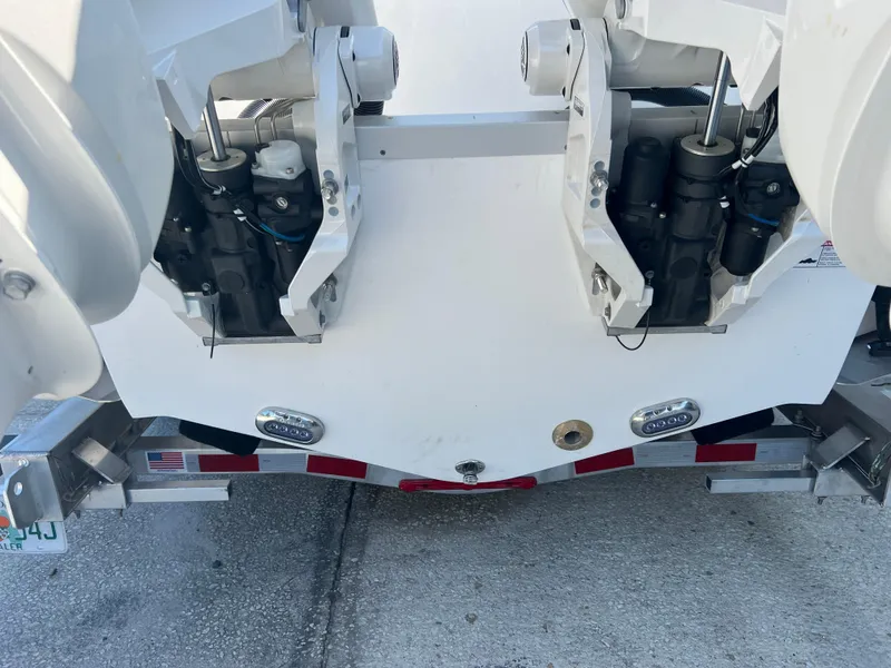 Slide: The Image of 2025 NauticStar 252L boat stern with dual outboard motors on a trailer. - 9