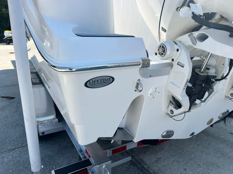 Slide: The Image of 2025 NauticStar 252L boat stern detail with lifetime warranty badge. - 10