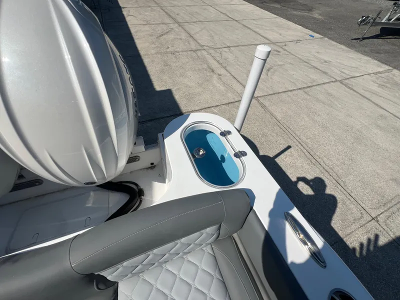 Slide: The Image of 2025 NauticStar 252L boat interior with seating and storage compartment. - 12