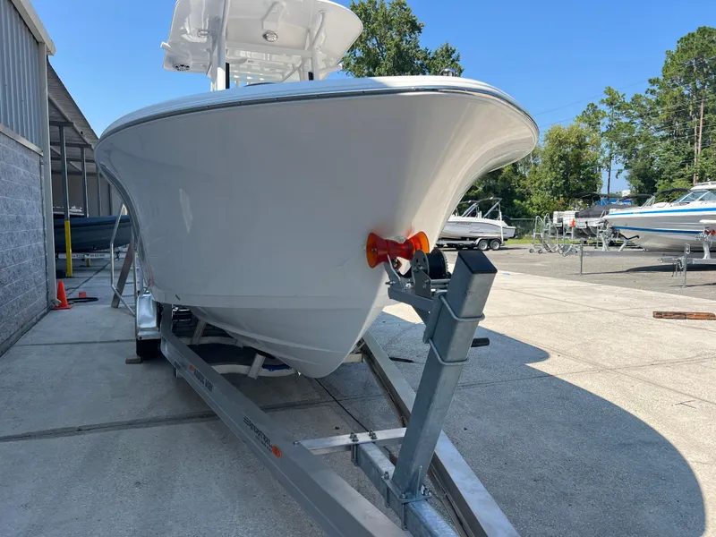 Slide: The Image of 2025 NauticStar 252L boat on trailer in outdoor storage area. - 2