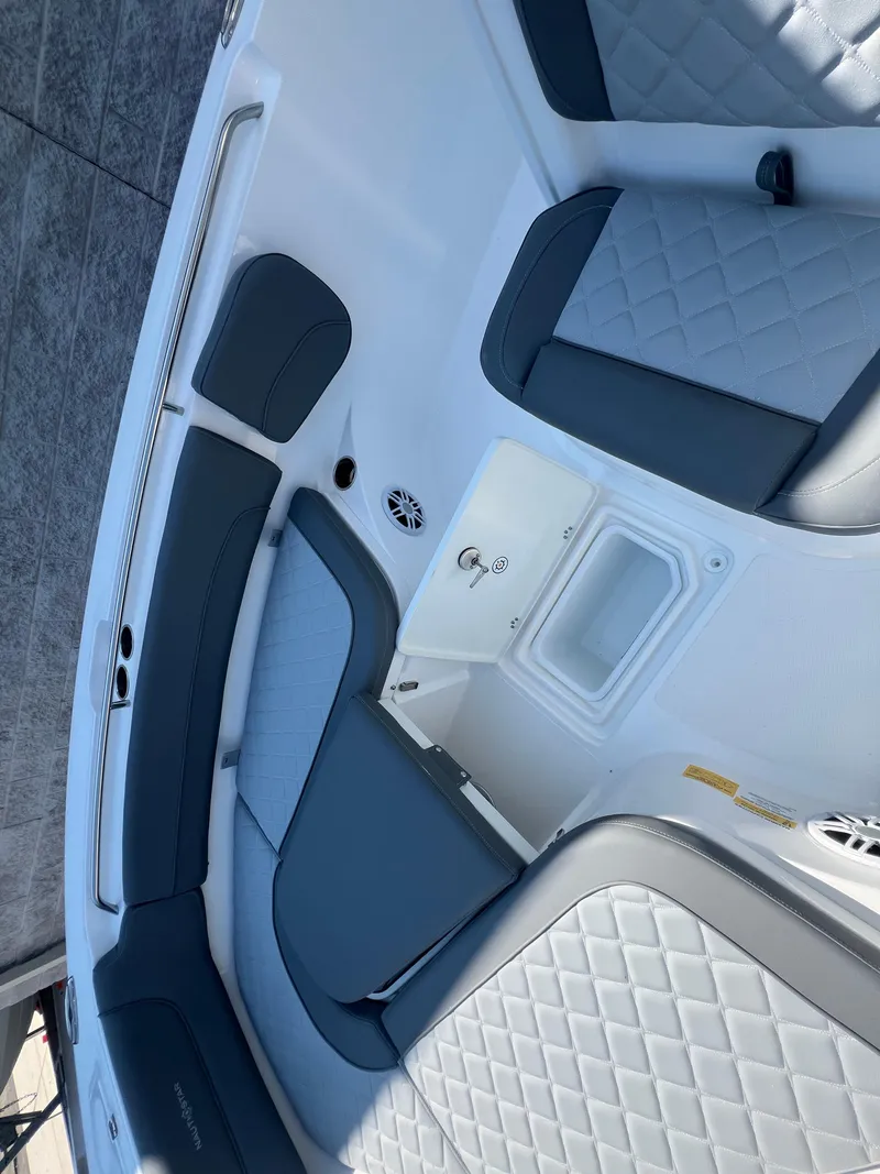 Slide: The Image of 2025 NauticStar 252L boat interior with gray seating and storage compartments. - 28
