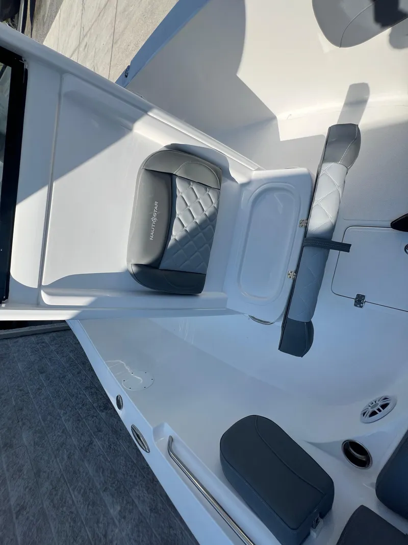Slide: The Image of 2025 NauticStar 252L boat interior with gray seating and modern design. - 29