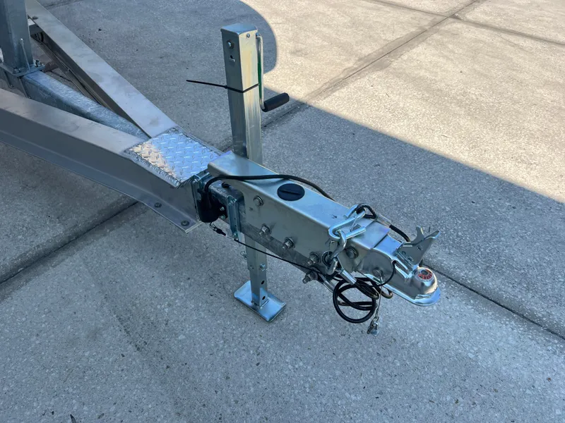 Slide: The Image of Trailer hitch of 2025 NauticStar 252L boat on concrete surface. - 34
