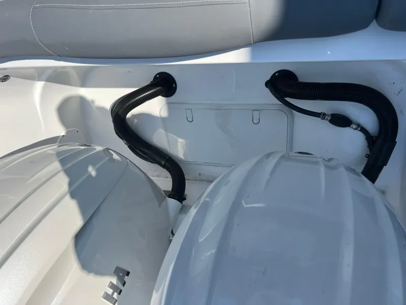Slide: The Image of 2025 NauticStar 252L boat interior with engine components and seating. - 35