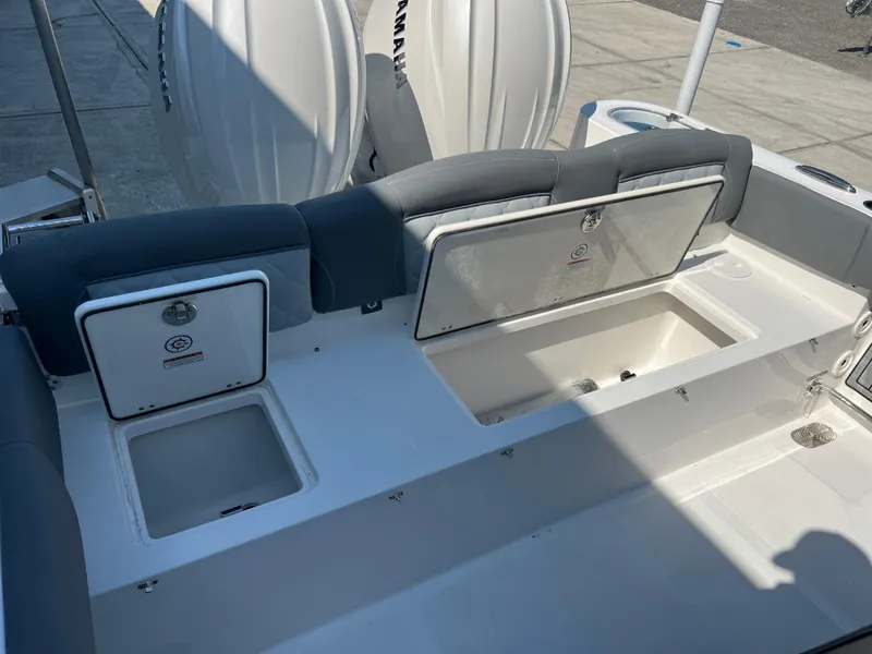 Slide: The Image of 2025 NauticStar 252L boat interior with storage compartments and seating. - 37