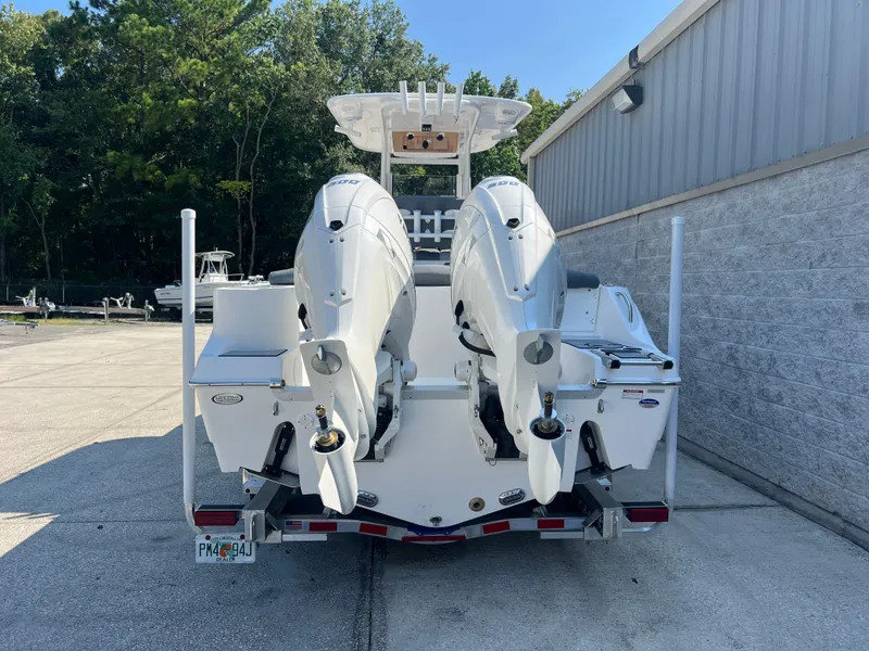 Slide: The Image of 2025 NauticStar 252L boat with dual engines, parked outdoors. - 4