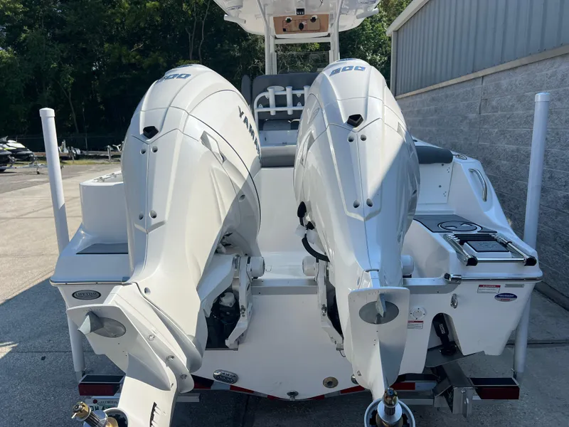 Slide: The Image of 2025 NauticStar 252L boat with dual Yamaha outboard engines, parked outdoors. - 5