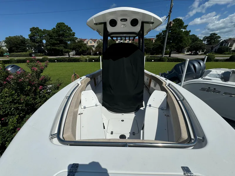 Slide: The Image of 2024 Sea Pro 222 Center Console boat, docked outdoors, showcasing spacious deck and console. - 3