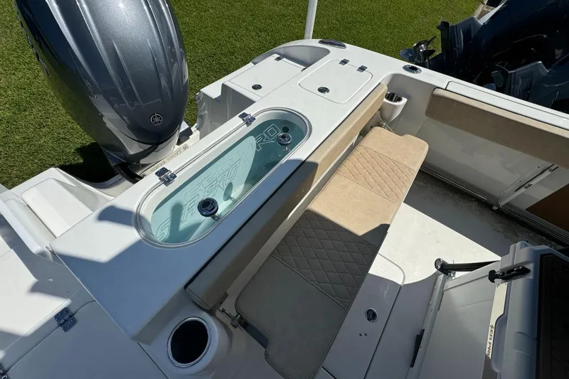 Slide: The Image of 2024 Sea Pro 222 Center Console boat interior with seating and storage compartments. - 5
