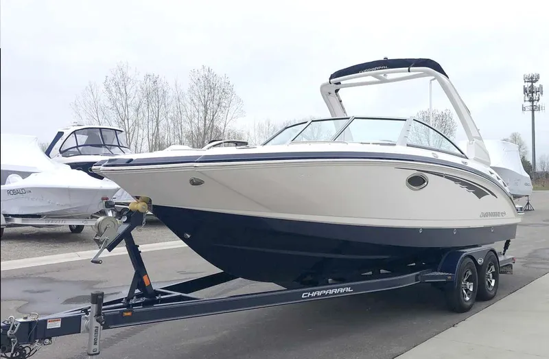 Slide: The Image of 2019 Chaparral 244 Sunesta boat on trailer, parked outdoors. - 0