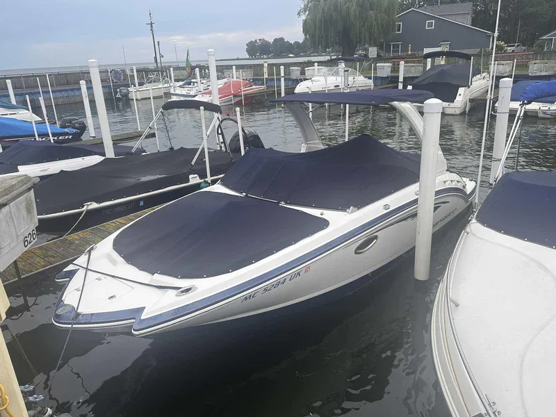 Slide: The Image of 2019 Chaparral 244 Sunesta boat docked with cover in marina. - 1