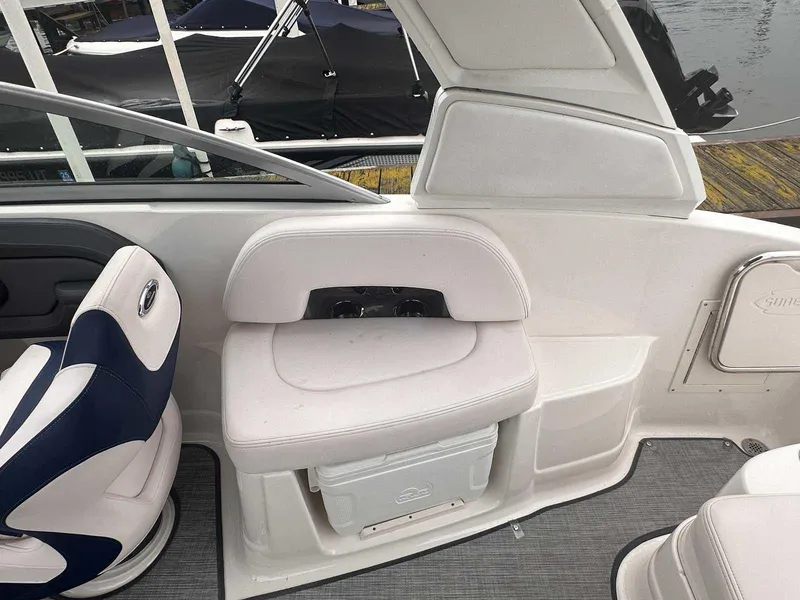 Slide: The Image of 2019 Chaparral 244 Sunesta boat interior with white seating and storage compartment. - 13