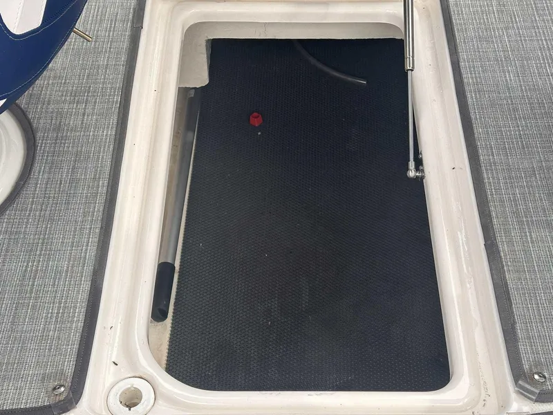 Slide: The Image of Storage compartment of 2019 Chaparral 244 Sunesta boat, open with visible interior. - 14