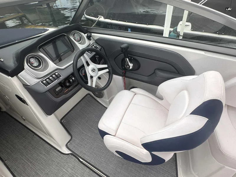 Slide: The Image of 2019 Chaparral 244 Sunesta boat cockpit with steering wheel and captain's chair. - 15