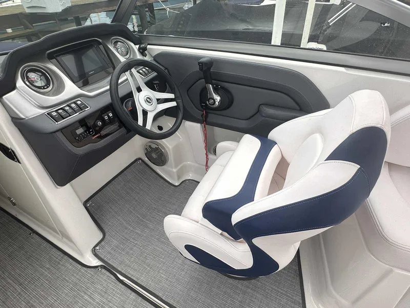 Slide: The Image of 2019 Chaparral 244 Sunesta boat interior with steering wheel and captain's chair. - 16