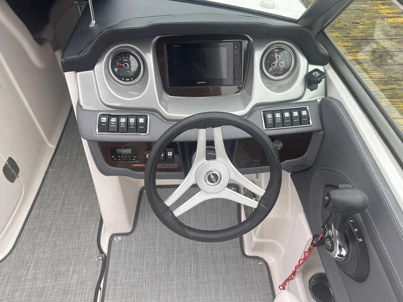 Slide: The Image of 2019 Chaparral 244 Sunesta boat dashboard with steering wheel and control panel. - 17