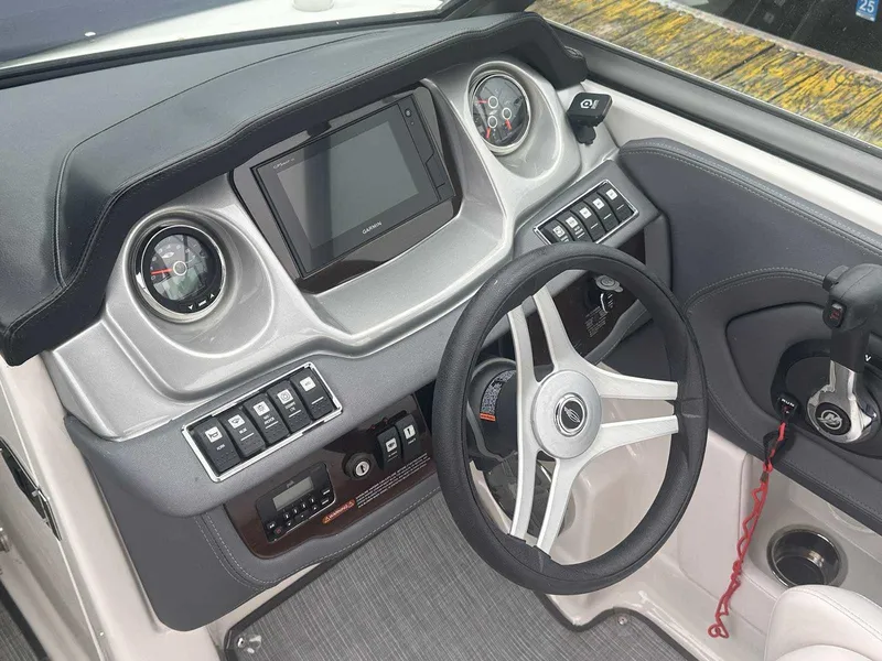 Slide: The Image of 2019 Chaparral 244 Sunesta boat dashboard with steering wheel and control panel. - 18