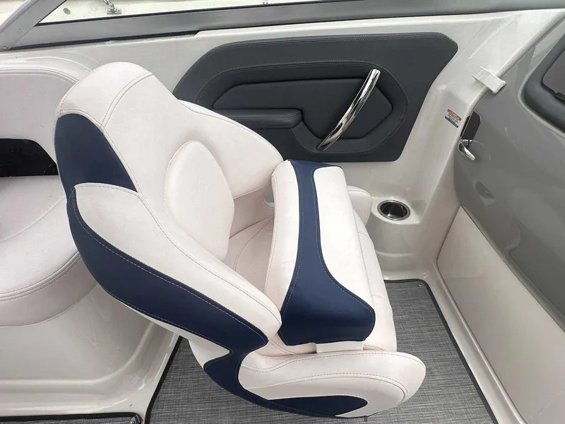 Slide: The Image of 2019 Chaparral 244 Sunesta boat interior with white and navy seating. - 19