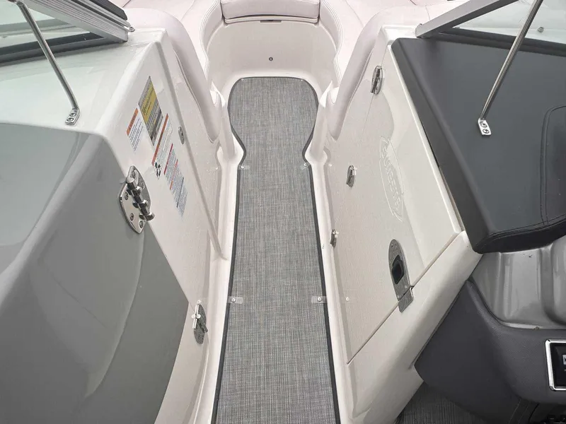Slide: The Image of 2019 Chaparral 244 Sunesta boat interior with gray flooring and white seating. - 24