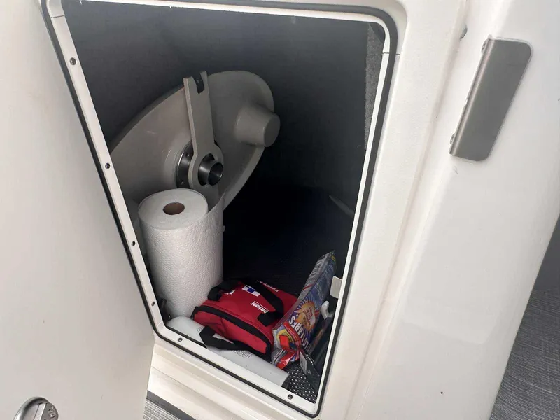 Slide: The Image of Storage compartment in 2019 Chaparral 244 Sunesta boat with supplies and equipment. - 25