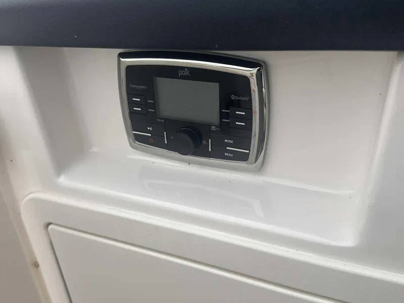 Slide: The Image of Polk audio system on 2019 Chaparral 244 Sunesta boat dashboard. - 26