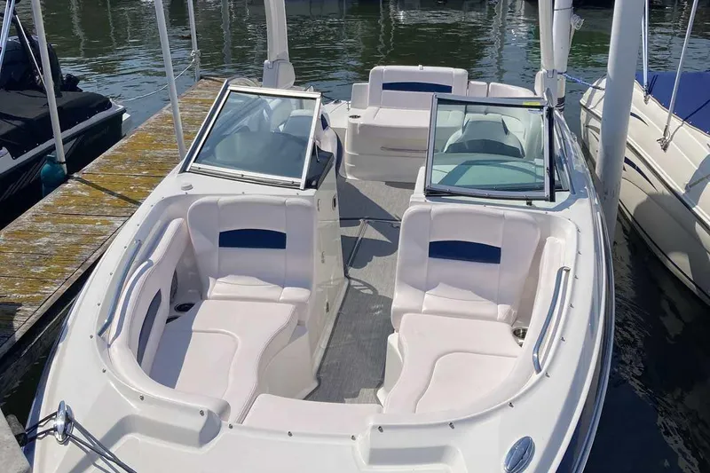Slide: The Image of 2019 Chaparral 244 Sunesta boat with spacious seating at a dock. - 27