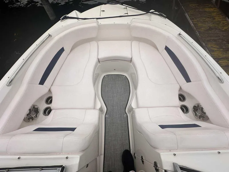 Slide: The Image of 2019 Chaparral 244 Sunesta boat interior with white seating and cup holders. - 28