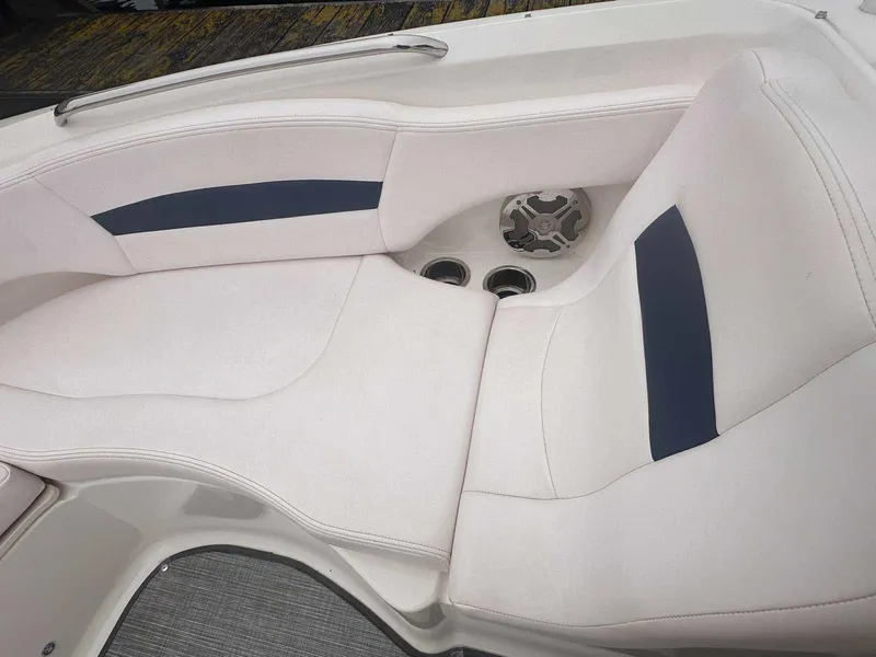 Slide: The Image of 2019 Chaparral 244 Sunesta boat interior seating with cup holders and speaker. - 31