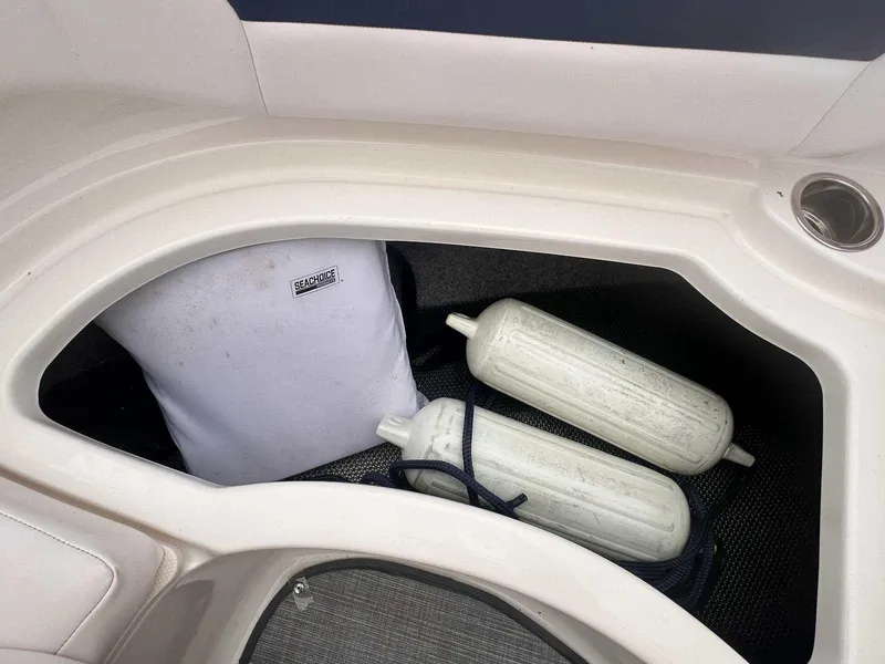 Slide: The Image of Storage compartment in 2019 Chaparral 244 Sunesta boat with fenders and gear. - 32