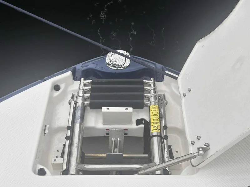 Slide: The Image of 2019 Chaparral 244 Sunesta boat ladder compartment with open hatch. - 33