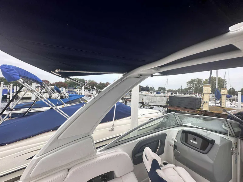 Slide: The Image of 2019 Chaparral 244 Sunesta boat interior with canopy at marina. - 37