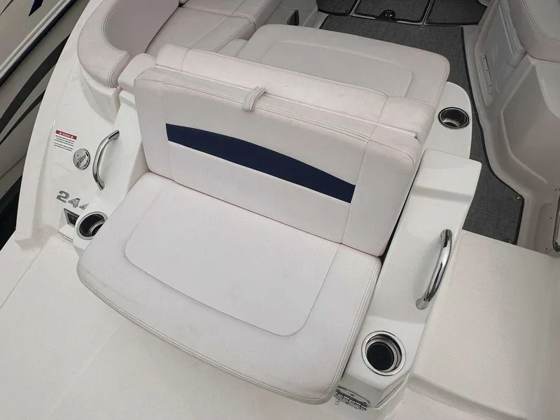 Slide: The Image of 2019 Chaparral 244 Sunesta boat seating with cup holders and white upholstery. - 5