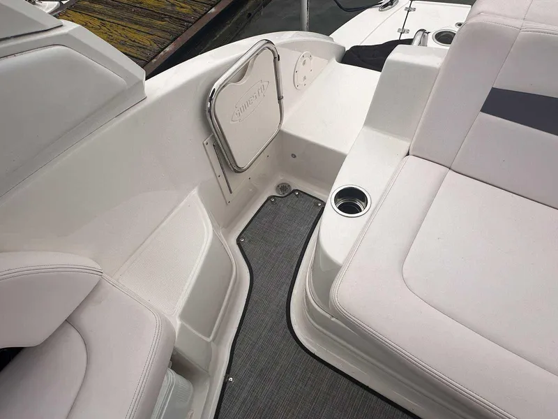 Slide: The Image of 2019 Chaparral 244 Sunesta boat interior with white seating and cup holders. - 8