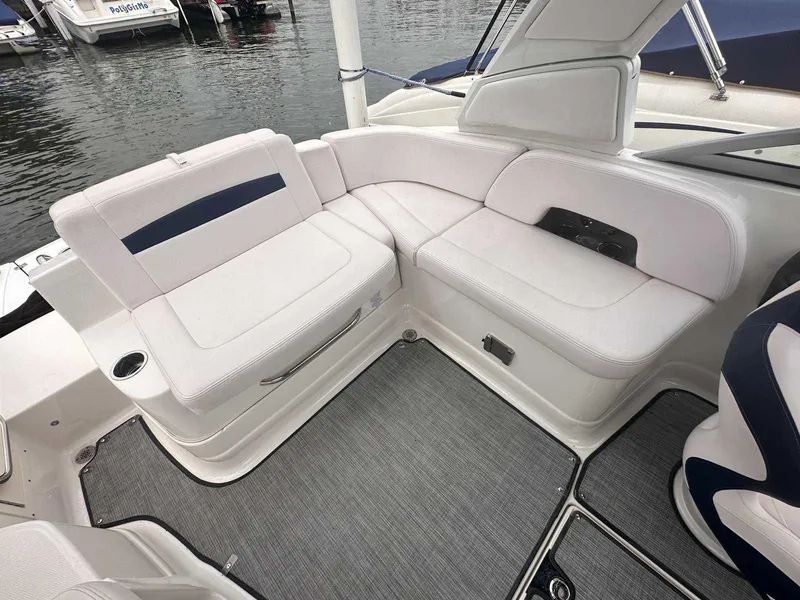 Slide: The Image of 2019 Chaparral 244 Sunesta boat interior with white seating and gray flooring. - 9