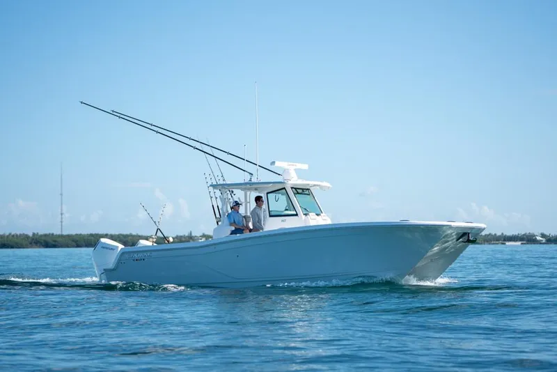 Slide: The Image of 2024 Caymas 34 CT boat cruising on clear blue water. - 1