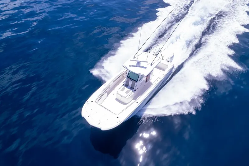 Slide: The Image of 2024 Caymas 34 CT boat cruising on open water, aerial view. - 11