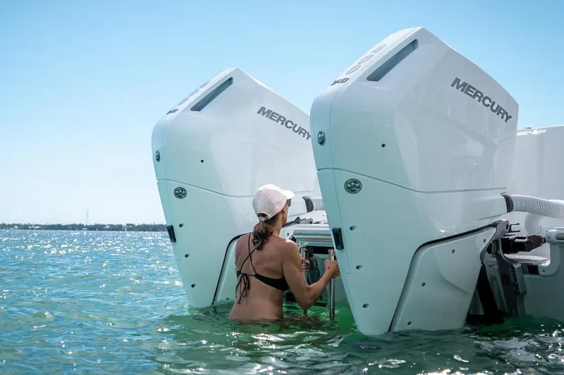 Slide: The Image of Person near 2024 Caymas 34 CT boat with Mercury engines in clear water. - 13