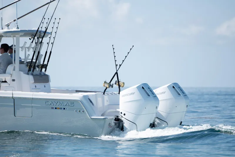 Slide: The Image of 2024 Caymas 34 CT boat with dual Mercury outboard engines on the ocean. - 16