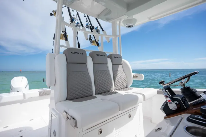 Slide: The Image of 2024 Caymas 34 CT boat interior with fishing rods and ocean view. - 17