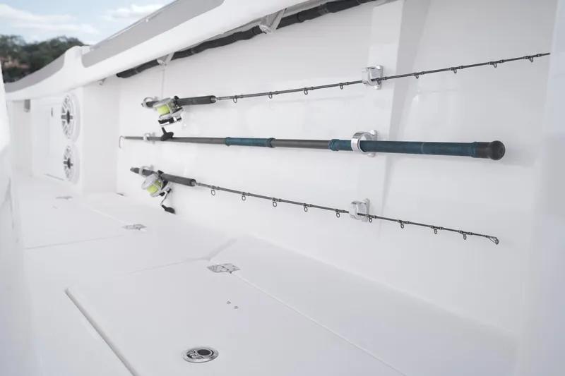 Slide: The Image of 2024 Caymas 34 CT boat with fishing rods secured on deck. - 19