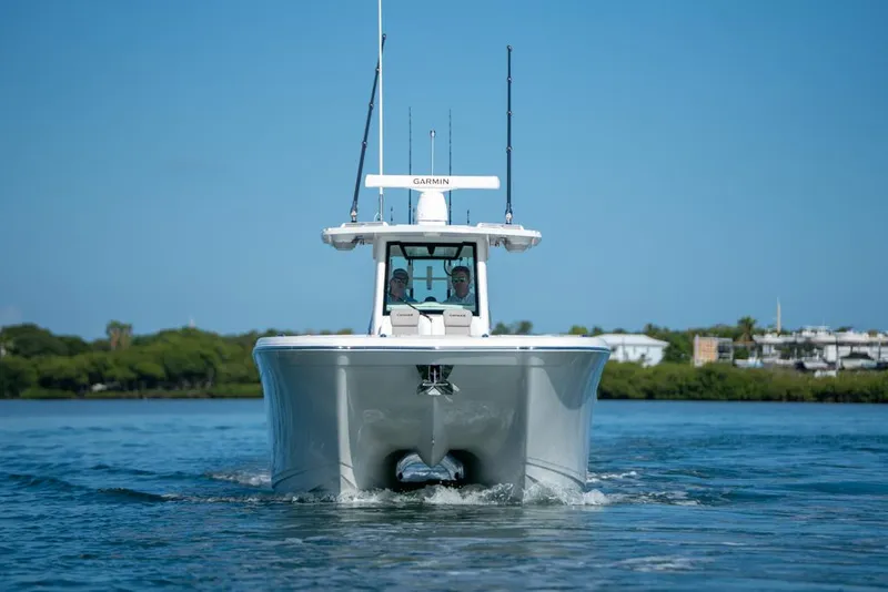 Slide: The Image of 2024 Caymas 34 CT boat cruising on a calm blue waterway. - 2