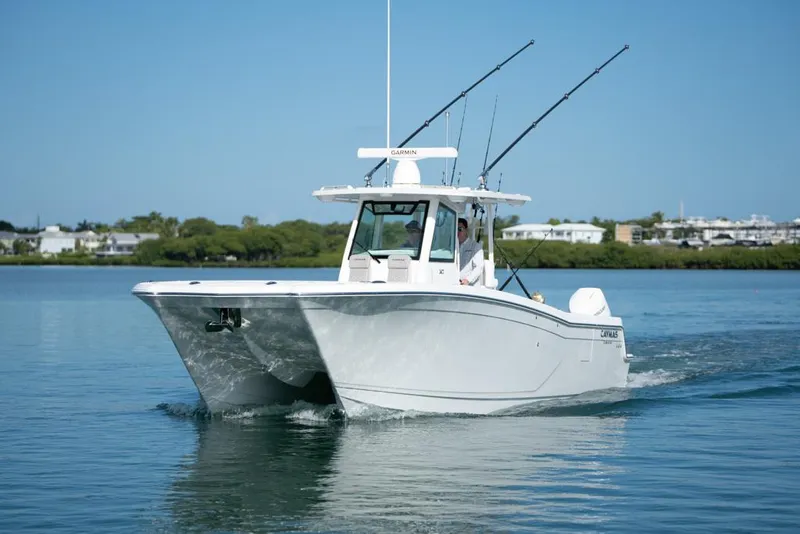 Slide: The Image of 2024 Caymas 34 CT boat cruising on calm water under clear blue sky. - 3